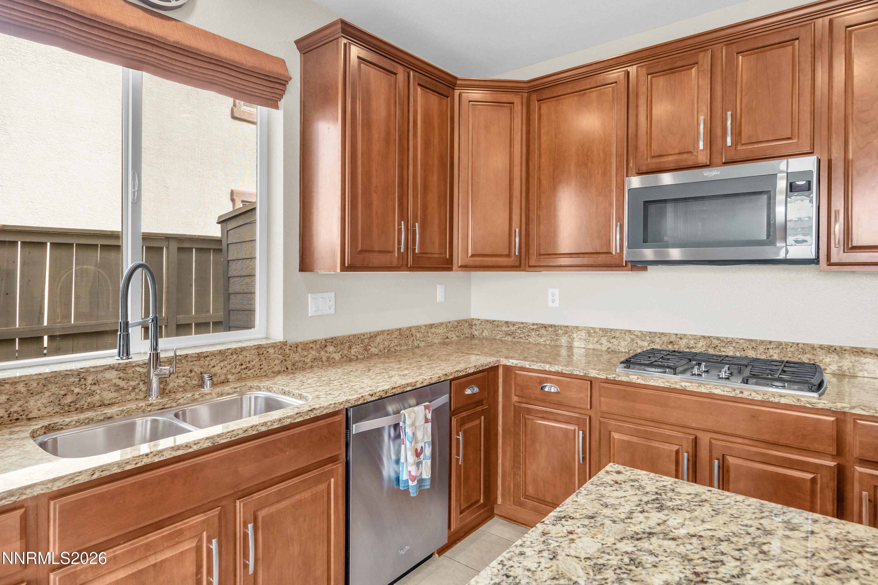 7119 Coldwater Street Sparks, NV 89436 - Photo 26 of 45 a kitchen with stainless steel appliances granite countertop a sink stove and microwave