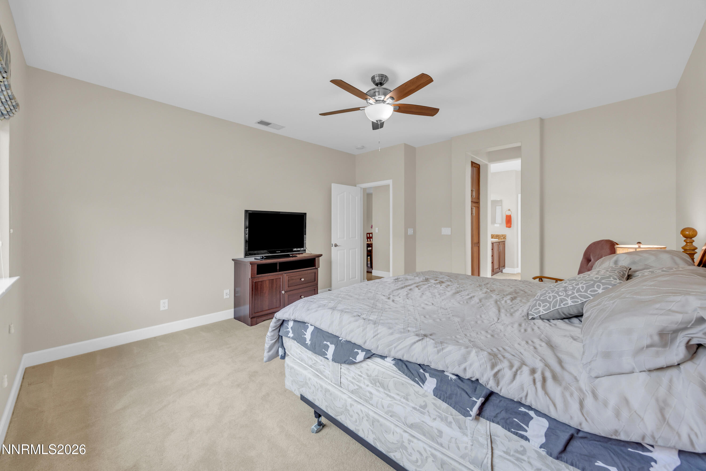7119 Coldwater Street Sparks, NV 89436 - Photo 31 of 45 a bedroom with a bed and a flat screen tv