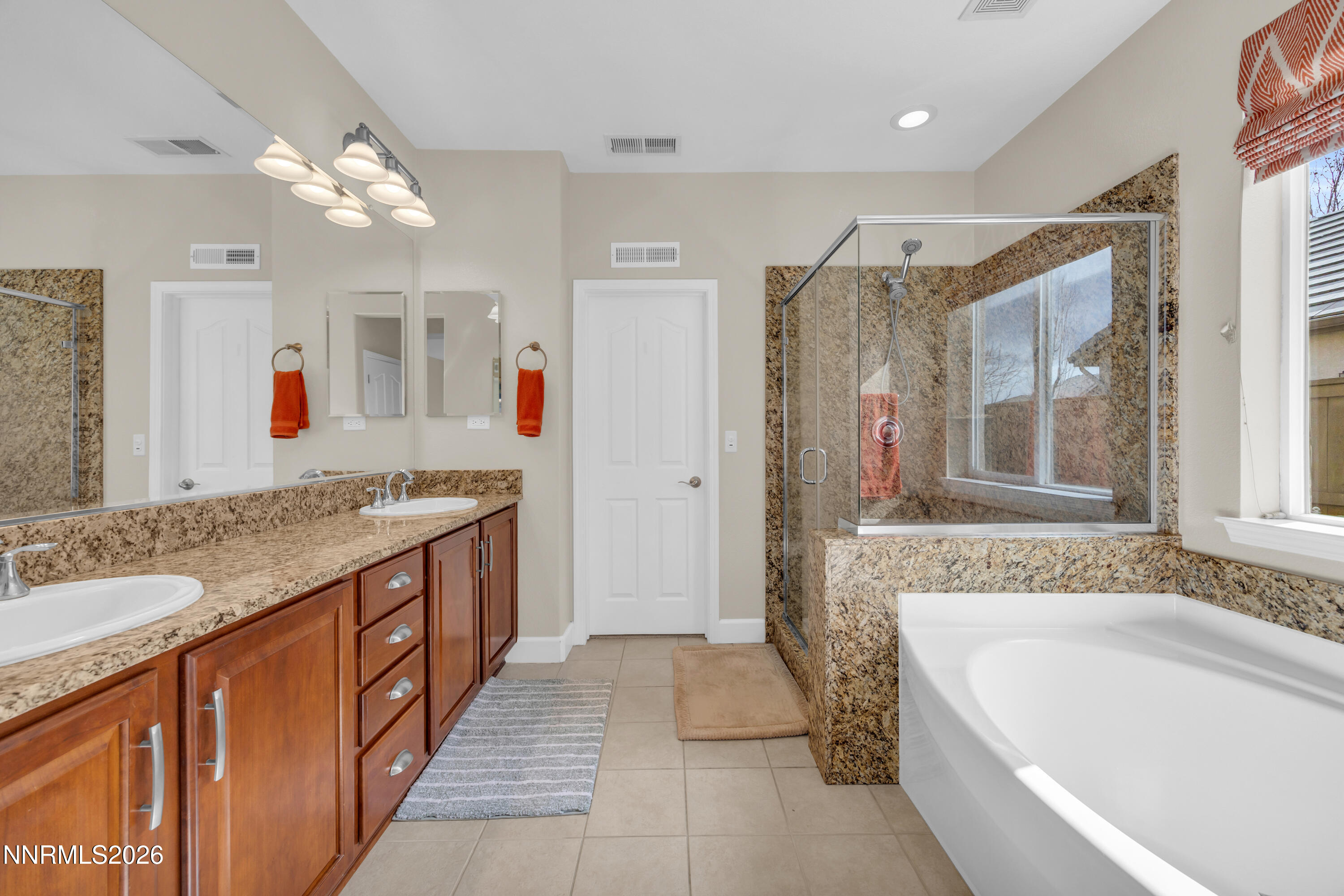 7119 Coldwater Street Sparks, NV 89436 - Photo 32 of 45 a bathroom with a granite countertop tub sink shower and mirror