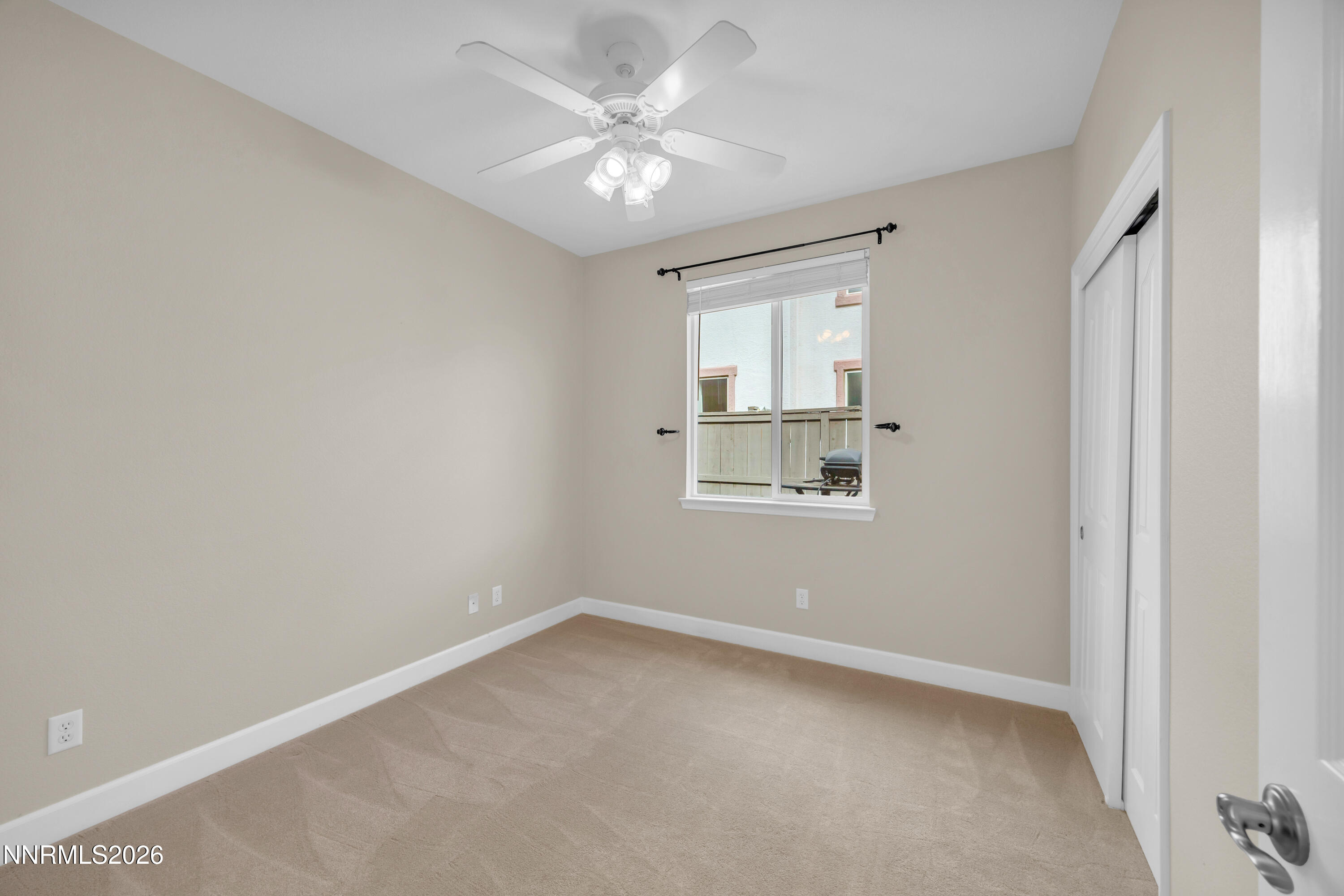 7119 Coldwater Street Sparks, NV 89436 - Photo 37 of 45 an empty room with a window and a ceiling fan