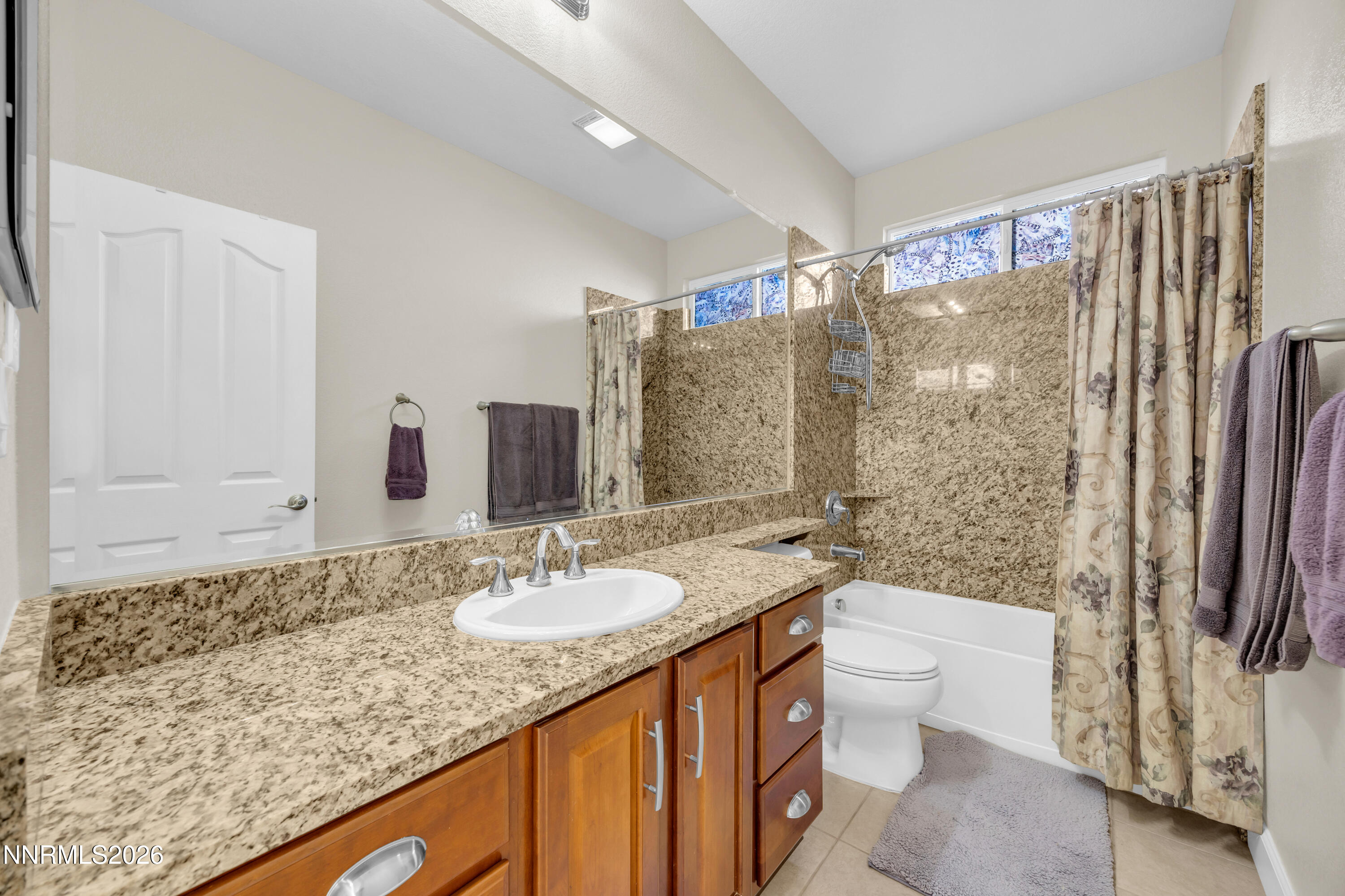 7119 Coldwater Street Sparks, NV 89436 - Photo 38 of 45 a bathroom with a granite countertop sink toilet and shower