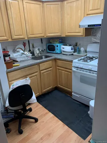 a kitchen with a sink a stove and cabinets