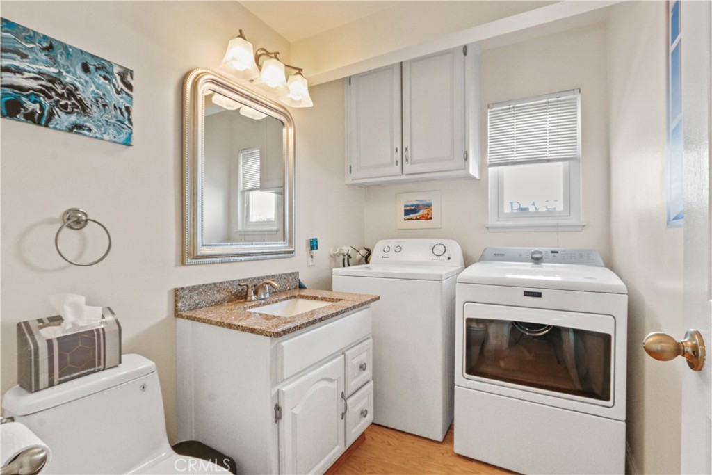 215 Valley Drive Hermosa Beach, CA 90254 - Photo 8 of 27 a kitchen with cabinets appliances and a sink