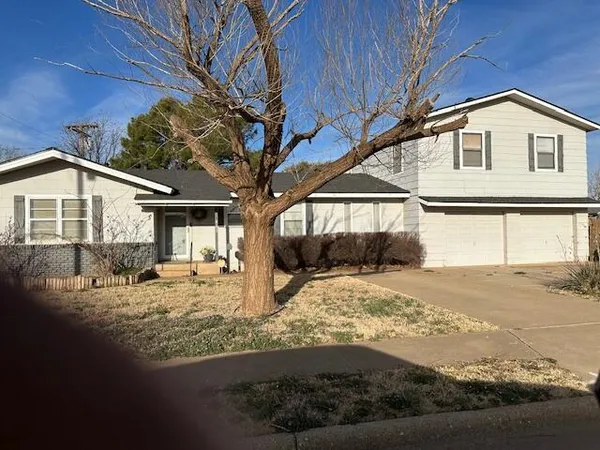 a view of a house with snow on the road