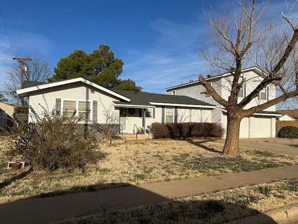 a front view of a house with yard covered in snow