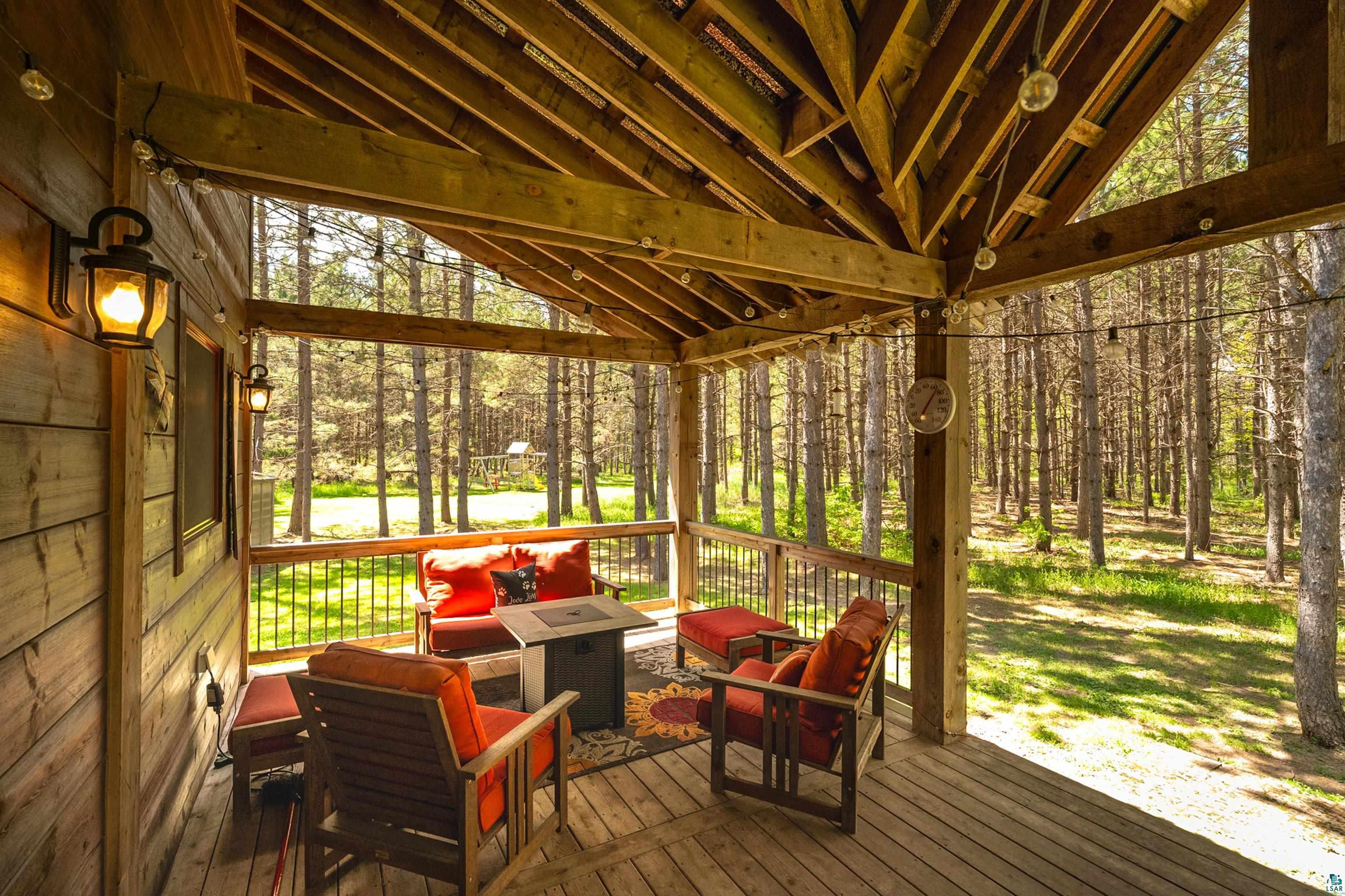 75 East Stark Road Esko, MN 55733 - Photo 64 of 87 Wood-finish covered porch featuring an exposed beam ceiling and string lighting