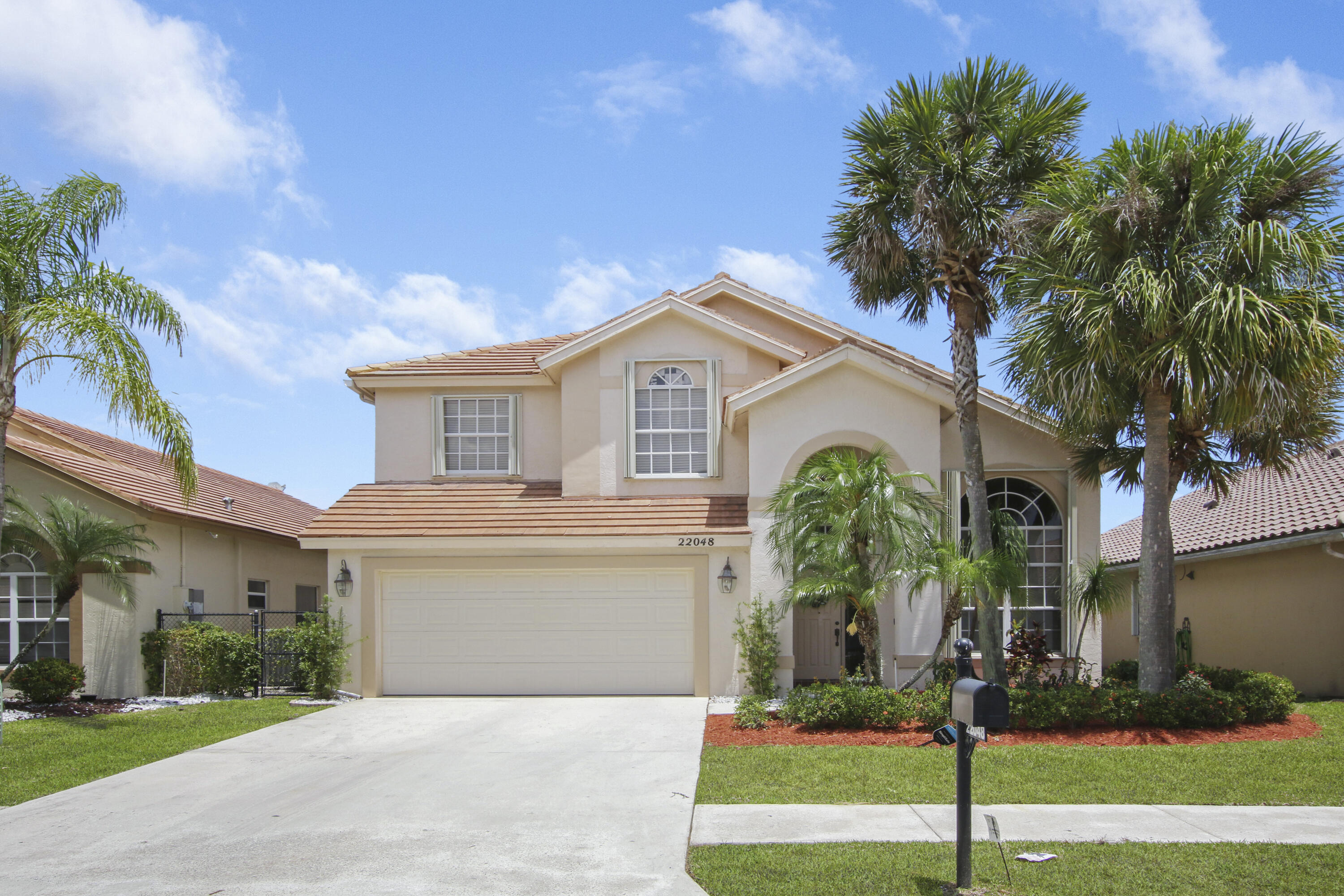 22048 Altona Drive Boca Raton, FL 33428 - Photo 1 of 33 a front view of a house with garden