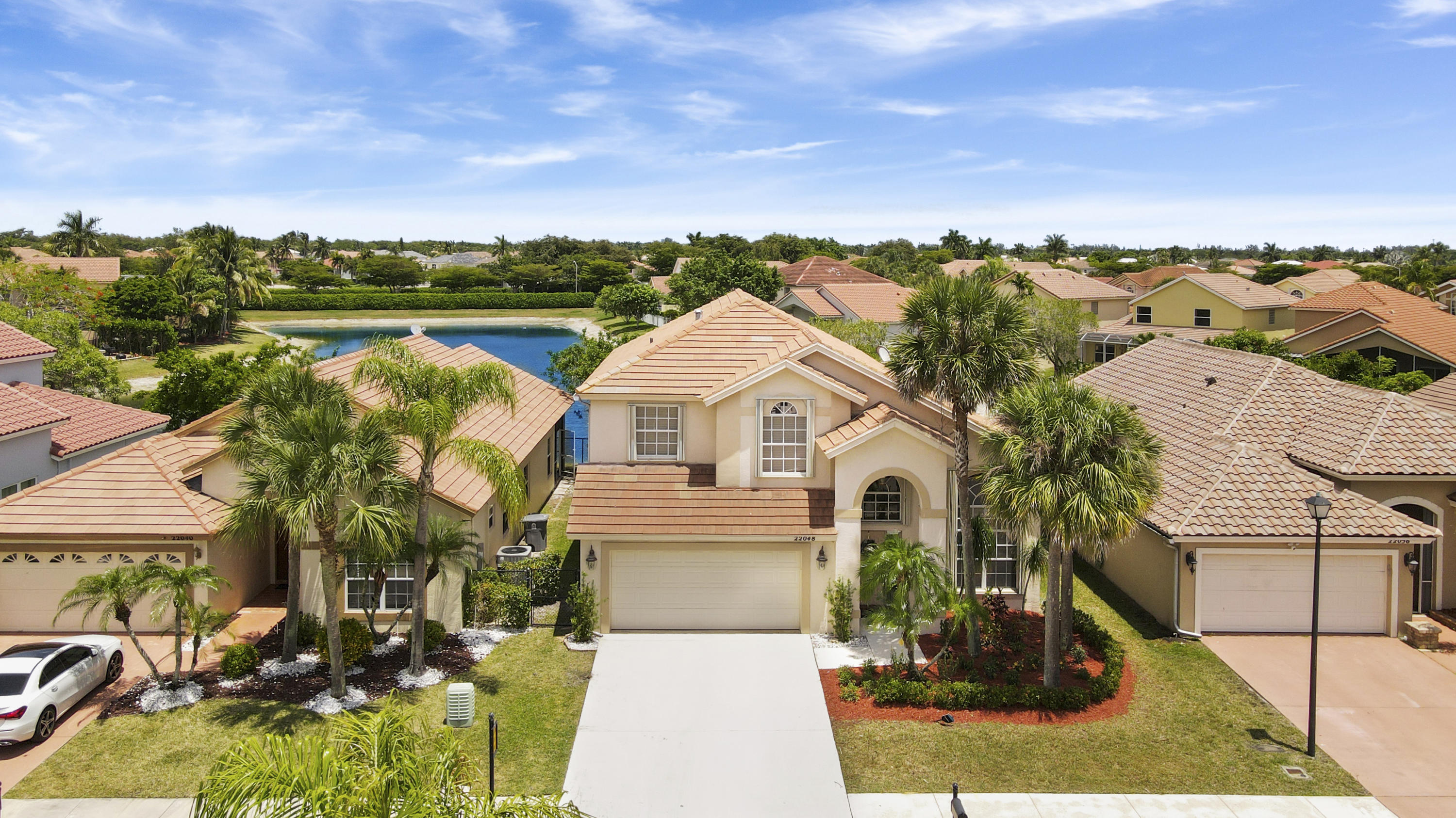 22048 Altona Drive Boca Raton, FL 33428 - Photo 2 of 33 an aerial view of a house with a garden and lake view