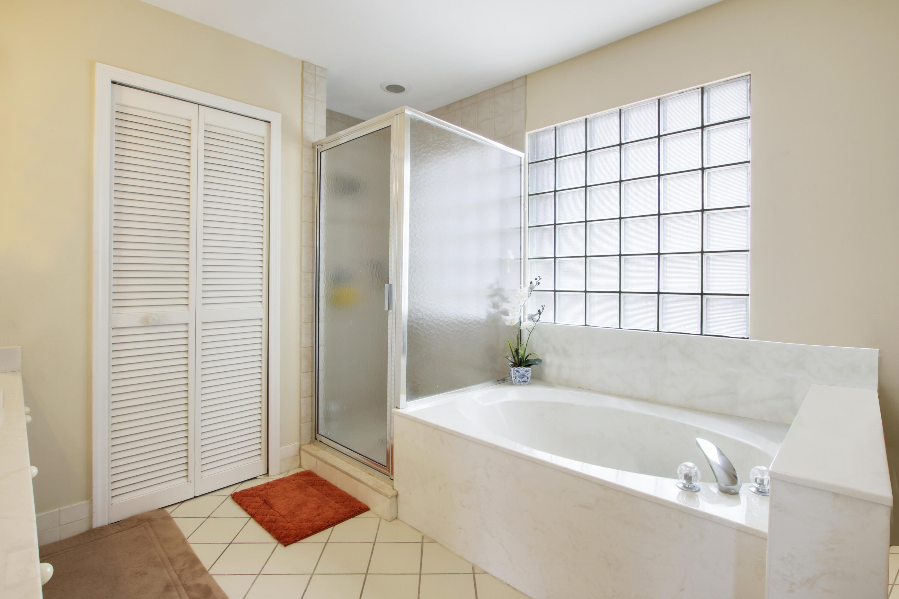 22048 Altona Drive Boca Raton, FL 33428 - Photo 22 of 33 a bathroom with a bathtub and next to a window