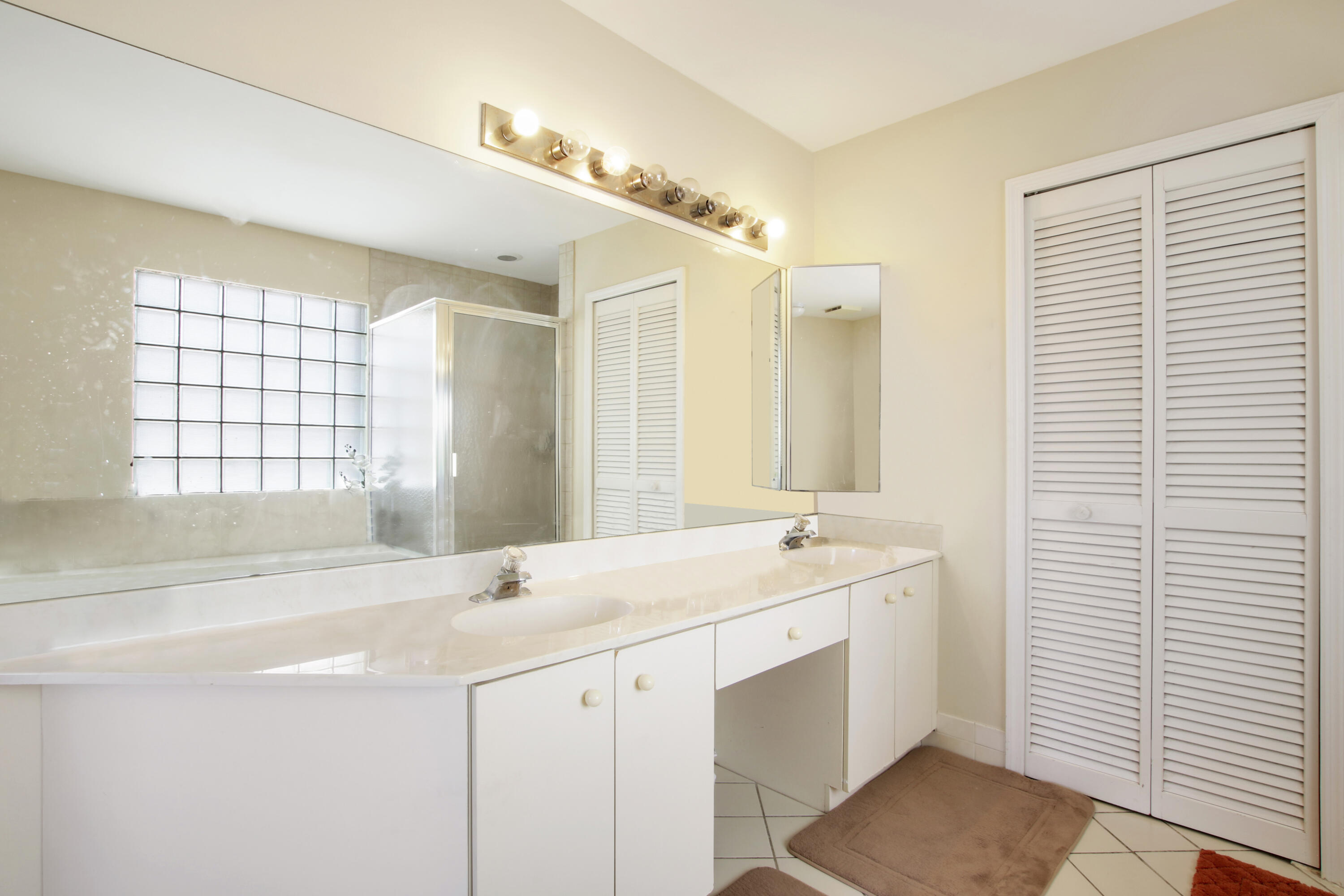 22048 Altona Drive Boca Raton, FL 33428 - Photo 23 of 33 a spacious bathroom with a double vanity sink a mirror and a shower