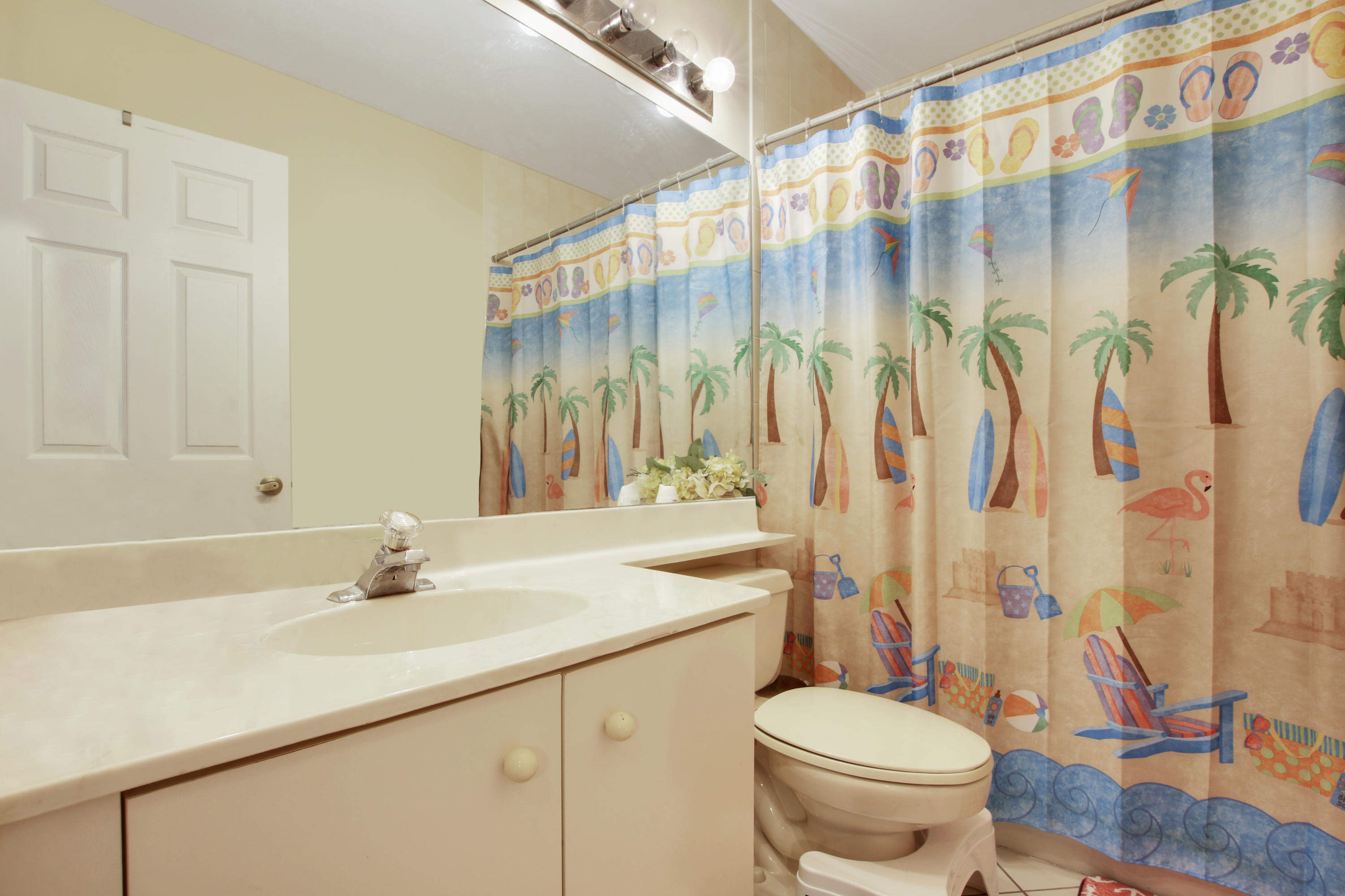 22048 Altona Drive Boca Raton, FL 33428 - Photo 25 of 33 a bathroom with a sink a toilet and a shower curtain