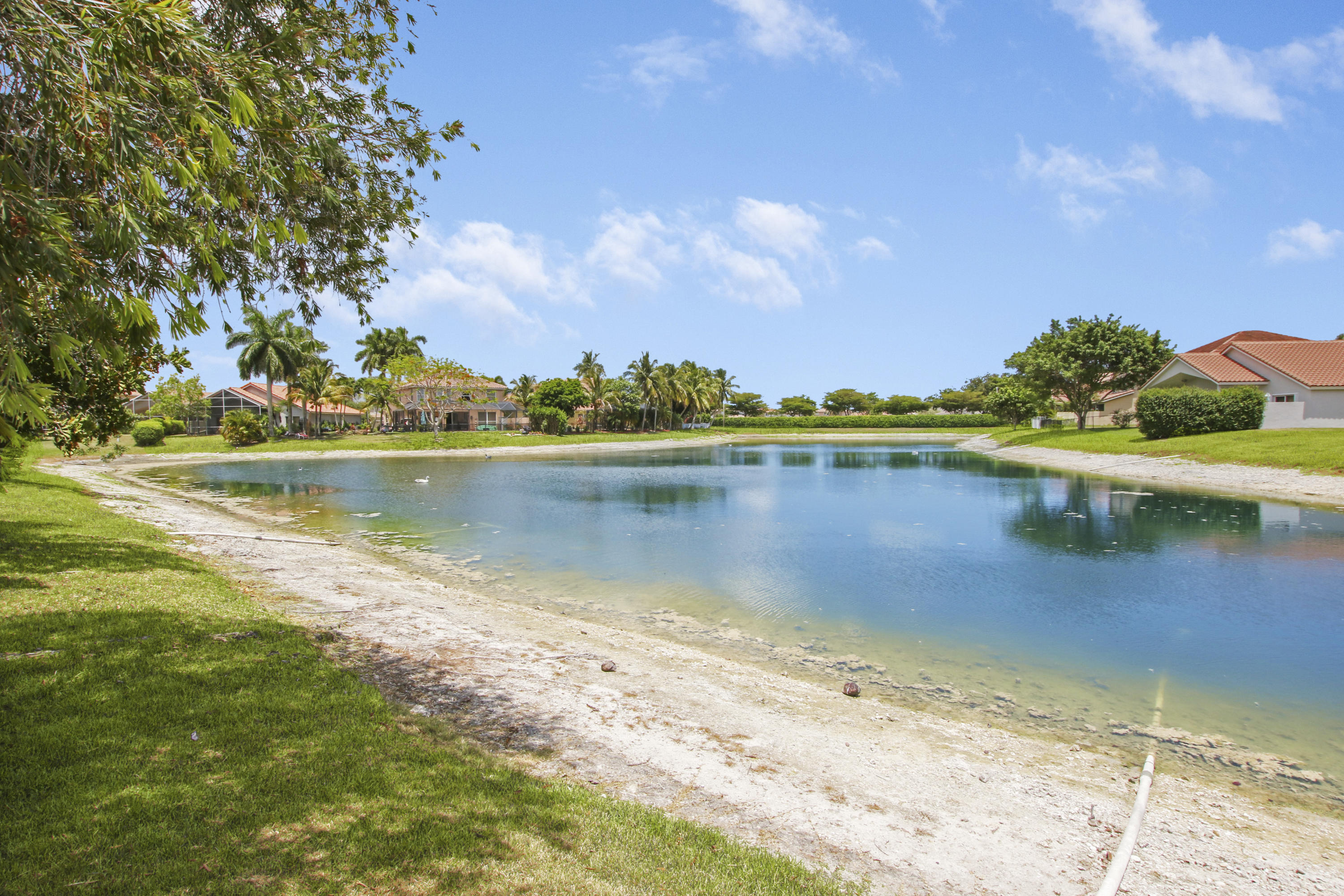 22048 Altona Drive Boca Raton, FL 33428 - Photo 29 of 33 a view of a lake with houses in the background