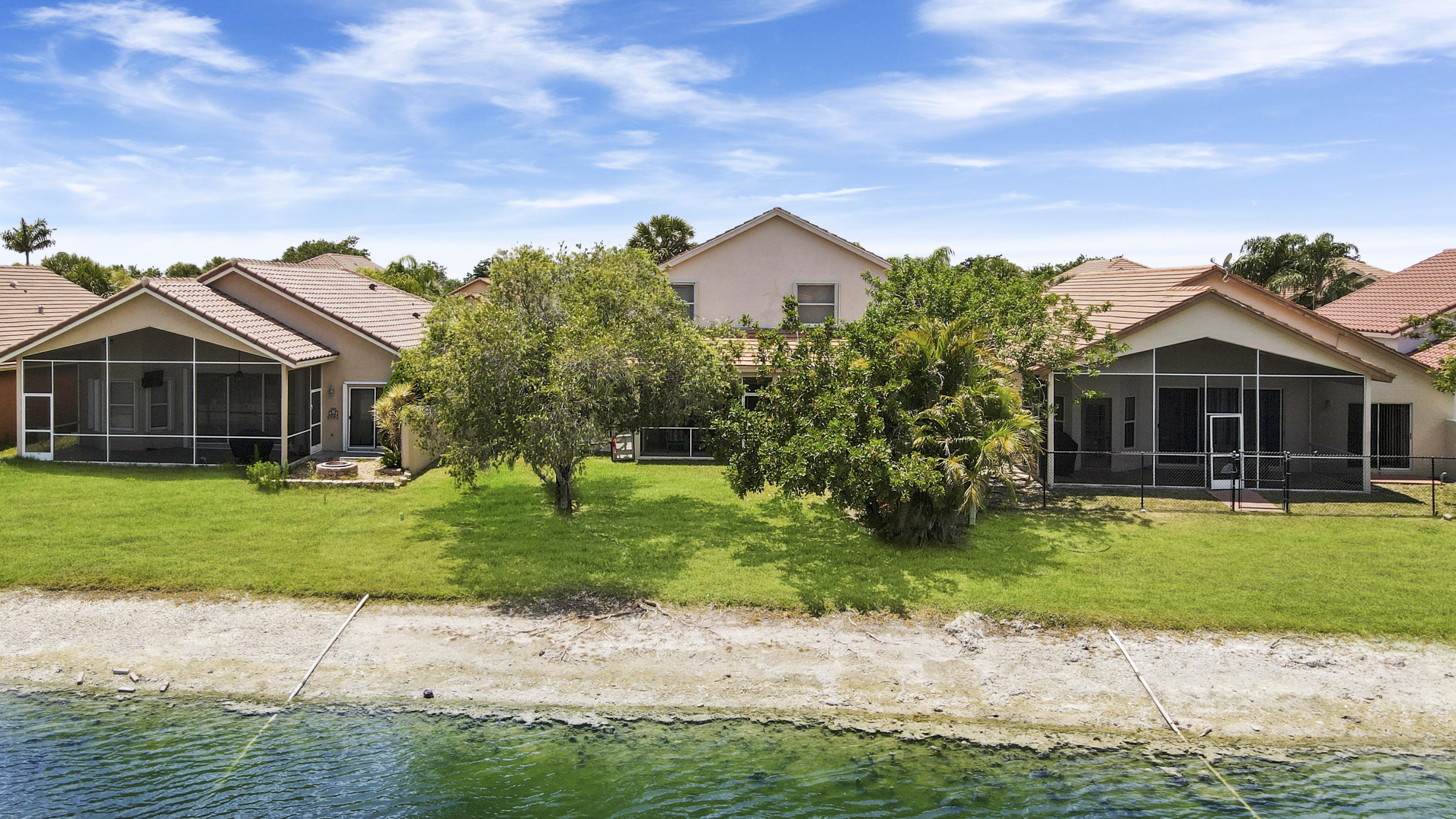 22048 Altona Drive Boca Raton, FL 33428 - Photo 30 of 33 a front view of a house with a garden and yard