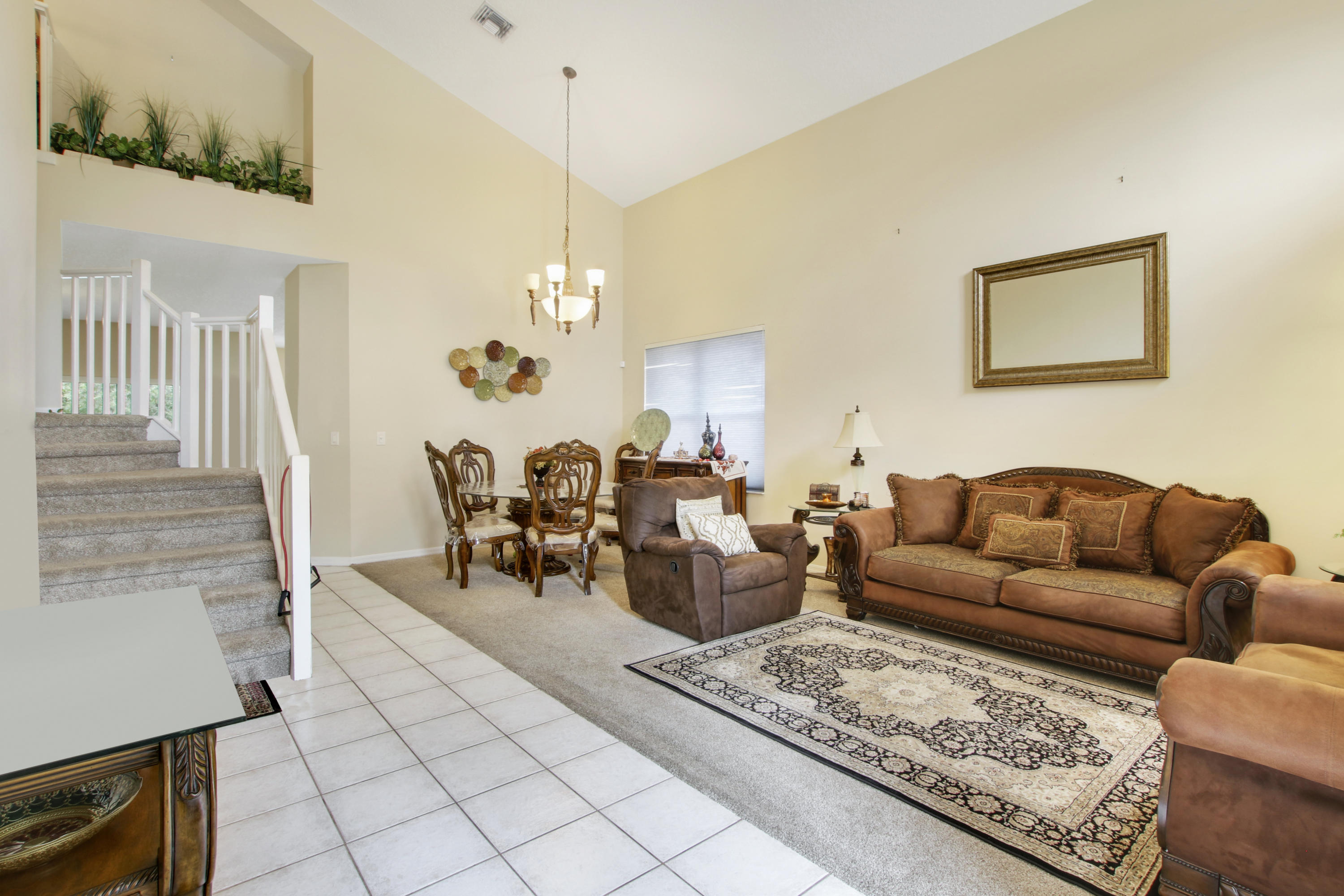 22048 Altona Drive Boca Raton, FL 33428 - Photo 5 of 33 a living room with furniture a dining table and a chandelier