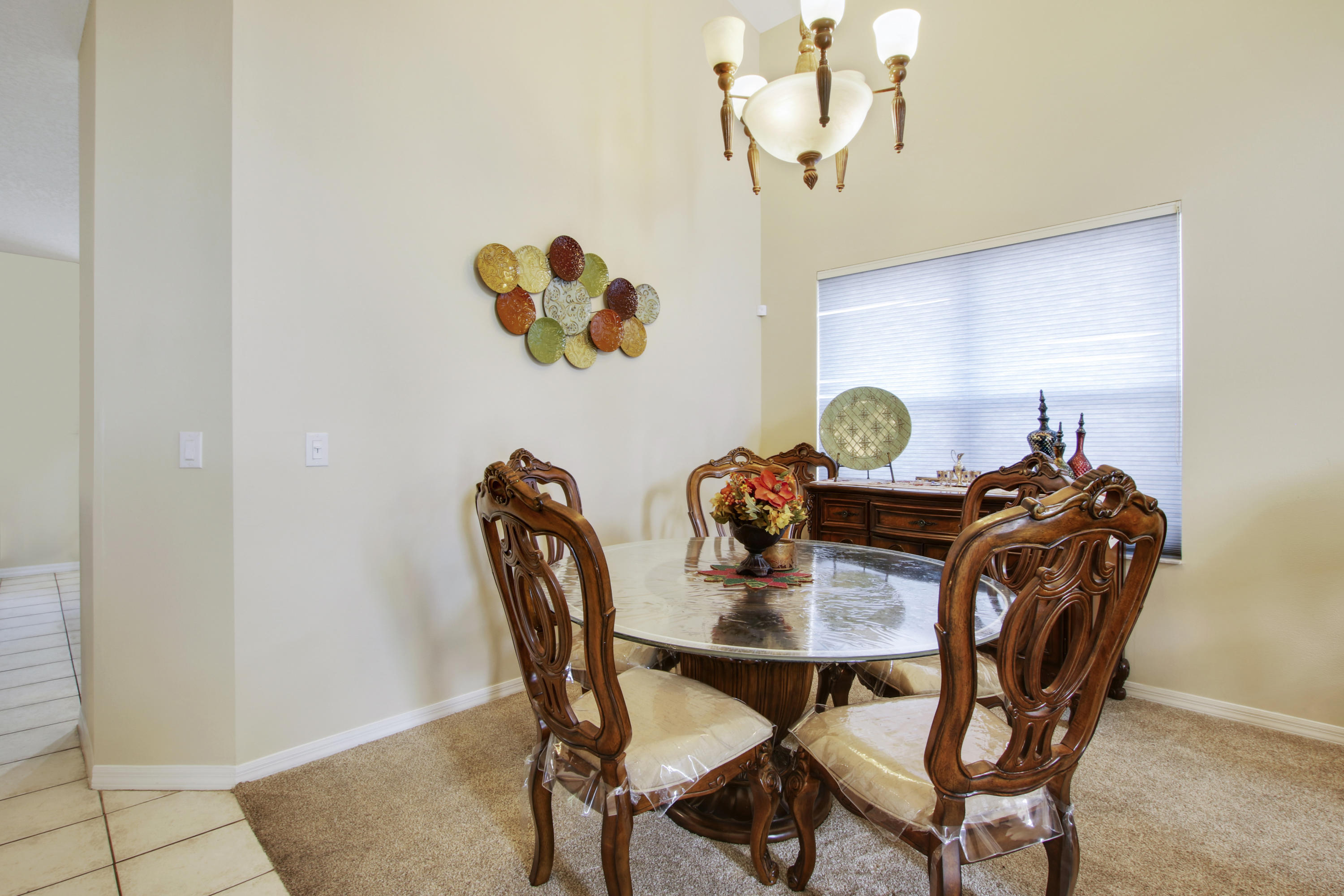 22048 Altona Drive Boca Raton, FL 33428 - Photo 8 of 33 a view of a dining room with furniture and chandelier