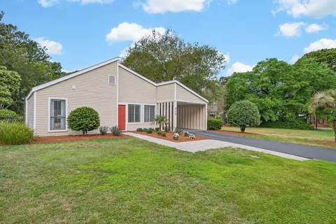 a front view of a house with patio and garden