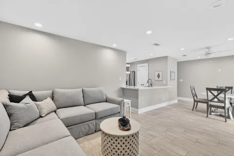 a living room with furniture and a wooden floor