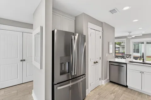 a kitchen with stainless steel appliances a refrigerator and a sink