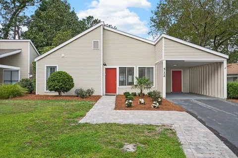 a view of a house with backyard and porch