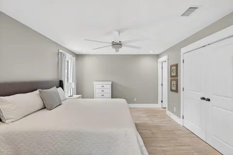 a bedroom with a large bed and a ceiling fan