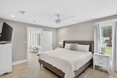 a bedroom with a bed and a flat screen tv