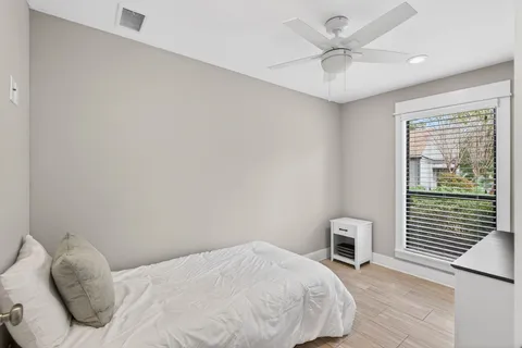 a bedroom with a bed and a chair