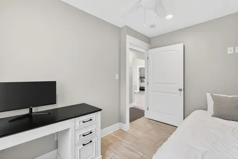 a bedroom with a bed and a flat screen tv