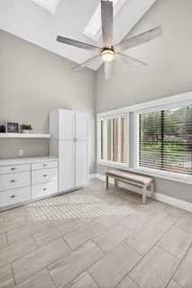 a view of a bedroom with cabinet window and a ceiling fan