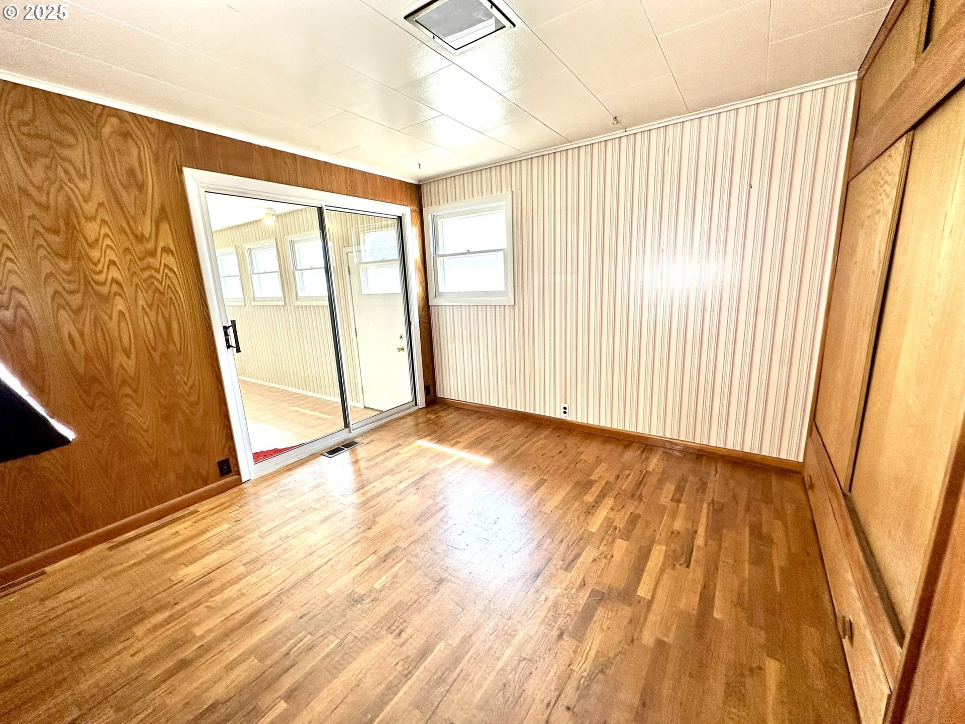 2460 Clark Street Baker City, OR 97814 - Photo 11 of 46 a view of an empty room with wooden floor and a window