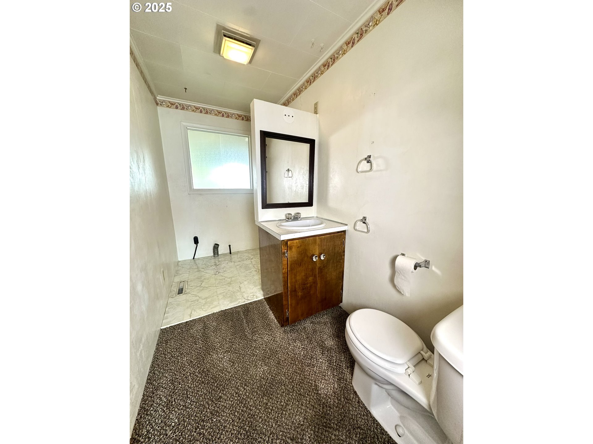 2460 Clark Street Baker City, OR 97814 - Photo 19 of 46 a spacious bathroom with a granite countertop toilet sink and mirror