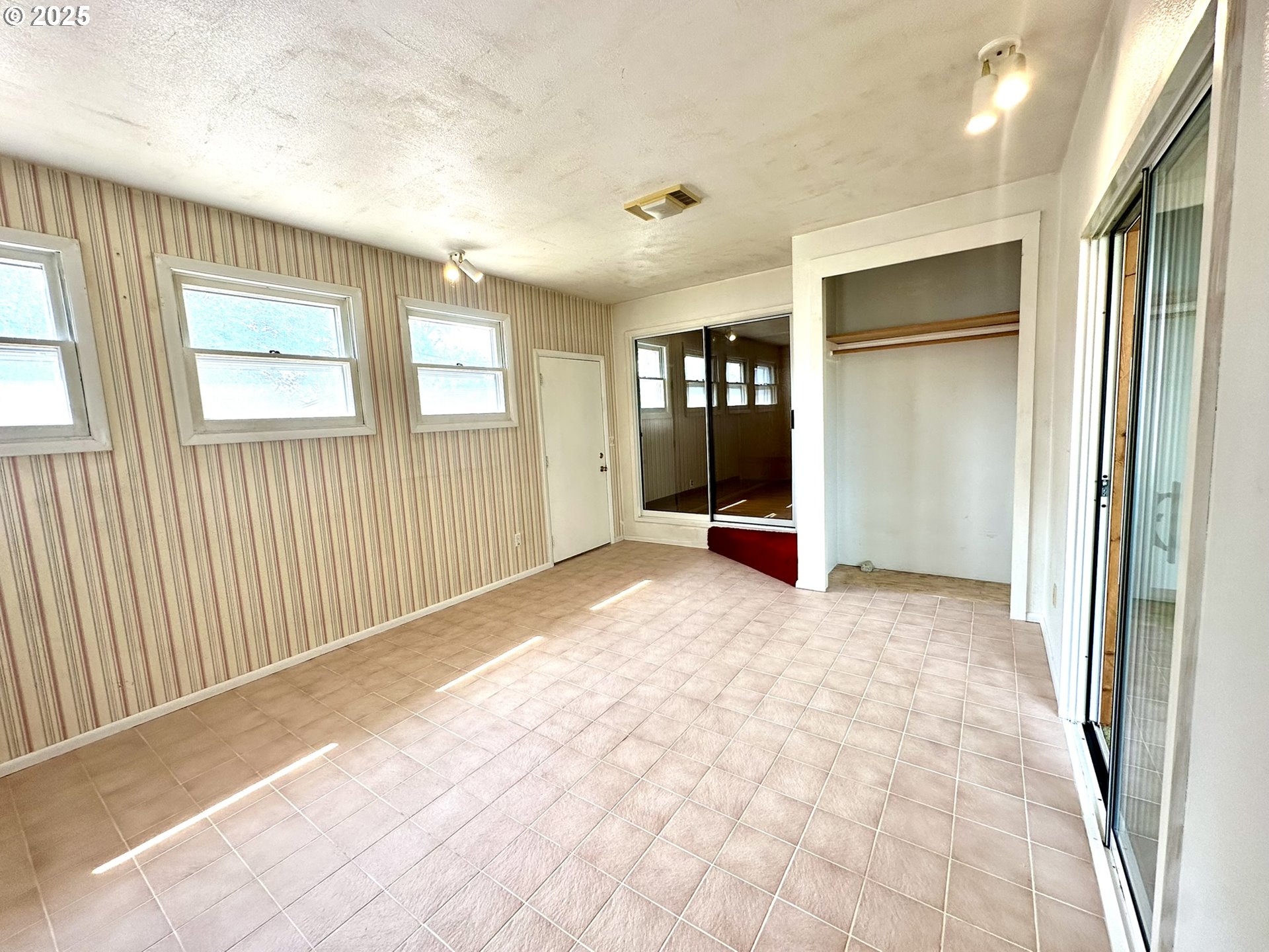 2460 Clark Street Baker City, OR 97814 - Photo 8 of 46 a view of an empty room with wooden floor and a window