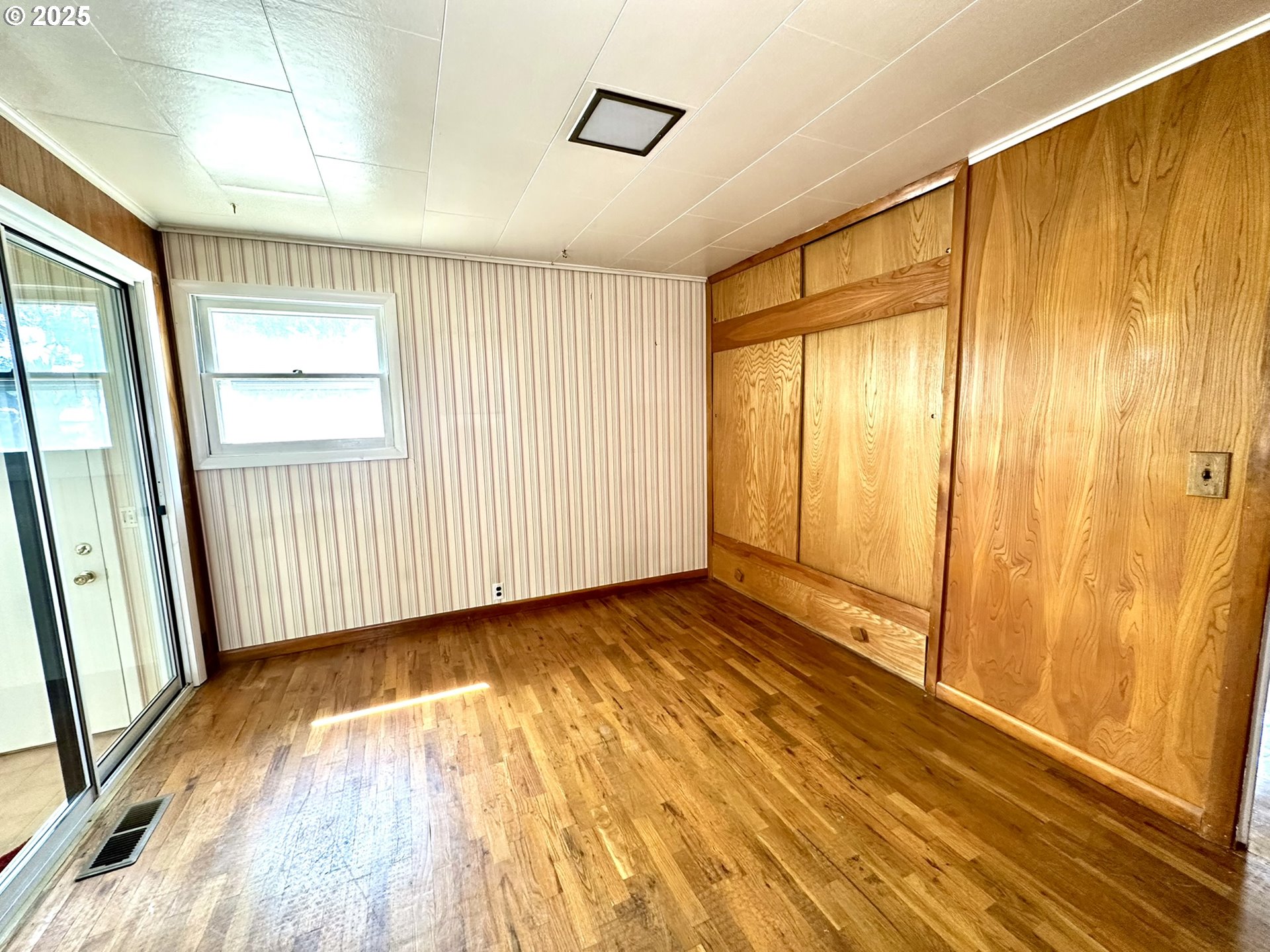 2460 Clark Street Baker City, OR 97814 - Photo 9 of 46 a view of an empty room with a window and hardwood floor