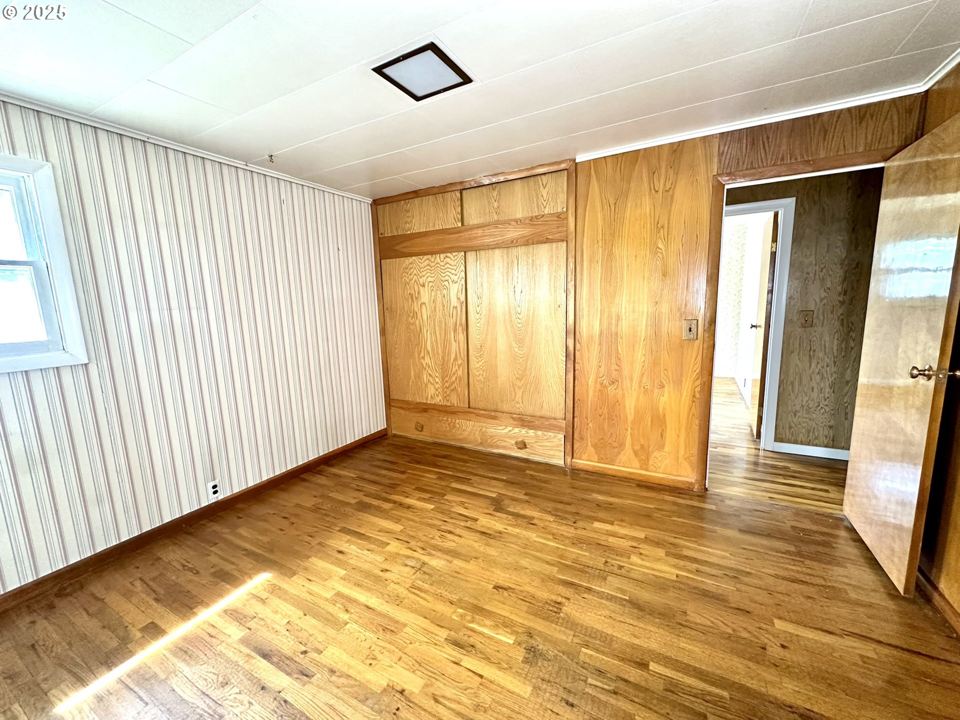 2460 Clark Street Baker City, OR 97814 - Photo 10 of 46 a view of an empty room with wooden floor and a window