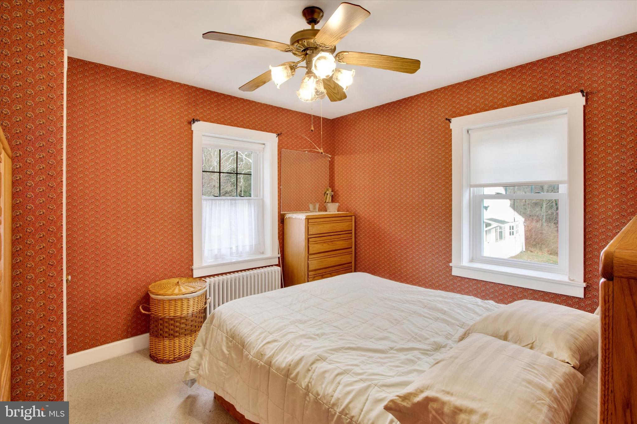 317 Oley Furnace Road Fleetwood, PA 19522 - Photo 17 of 43 a bedroom with a bed and a chandelier