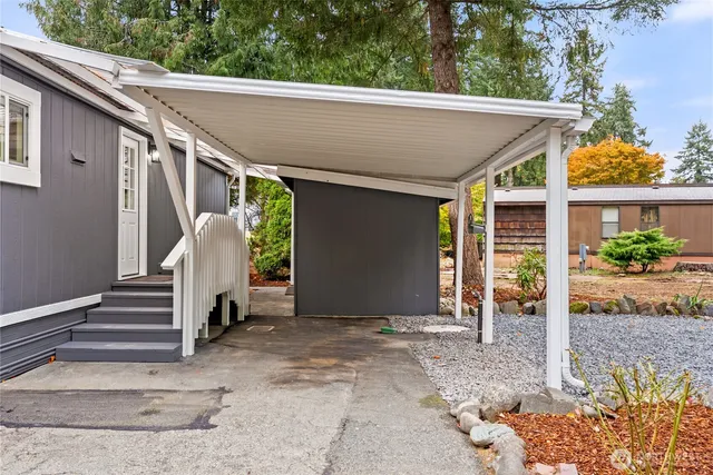 a view of a patio with table and chairs with wooden fence and plants