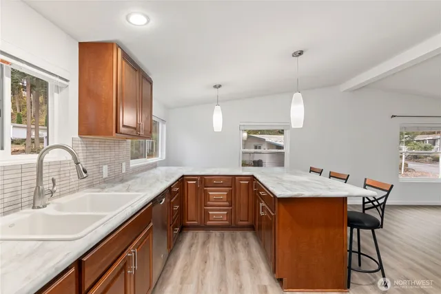 a kitchen with kitchen island a sink stove and refrigerator