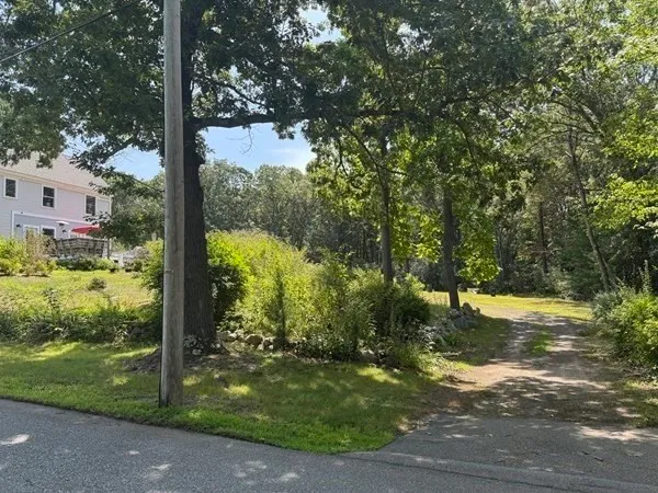 a backyard of a house with a yard and outdoor seating
