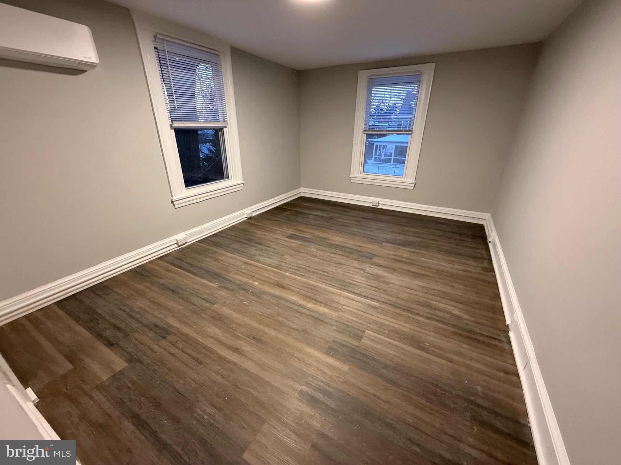 212 Warren Street Beverly, NJ 08010 - Photo 19 of 33 an empty room with wooden floor and windows