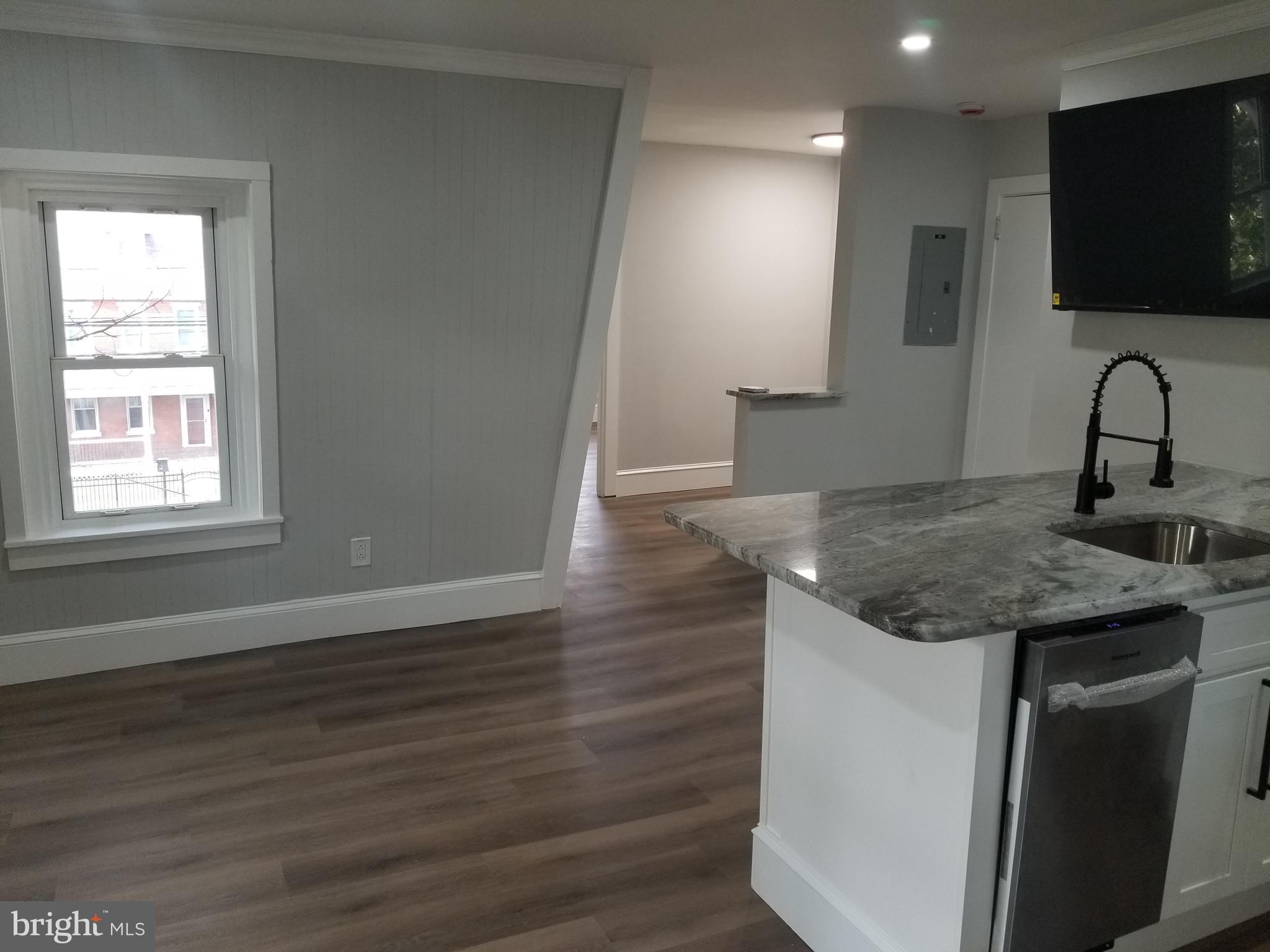 212 Warren Street Beverly, NJ 08010 - Photo 24 of 33 a kitchen with a sink and a mirror
