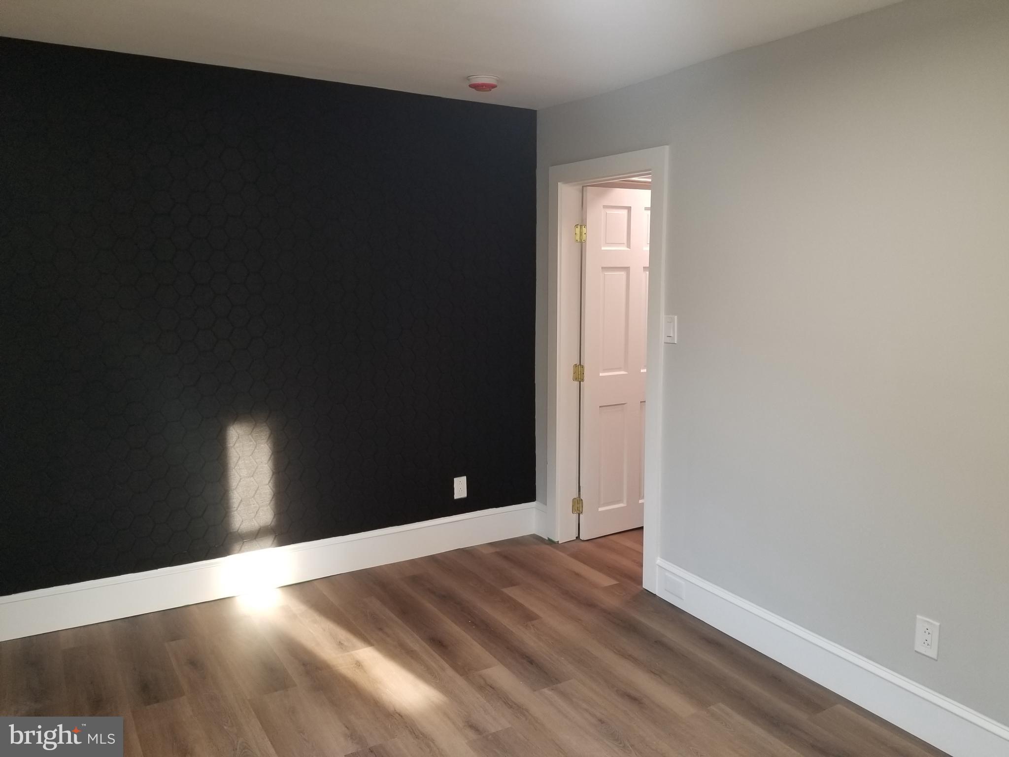 212 Warren Street Beverly, NJ 08010 - Photo 25 of 33 a view of empty room with wooden floor and fan