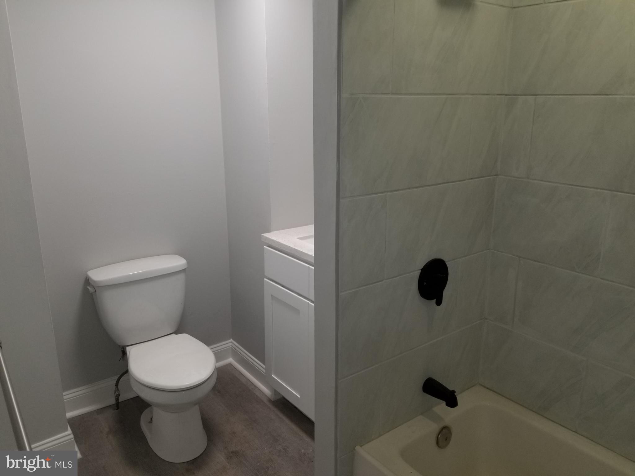 212 Warren Street Beverly, NJ 08010 - Photo 32 of 33 a bathroom with a toilet and a shower