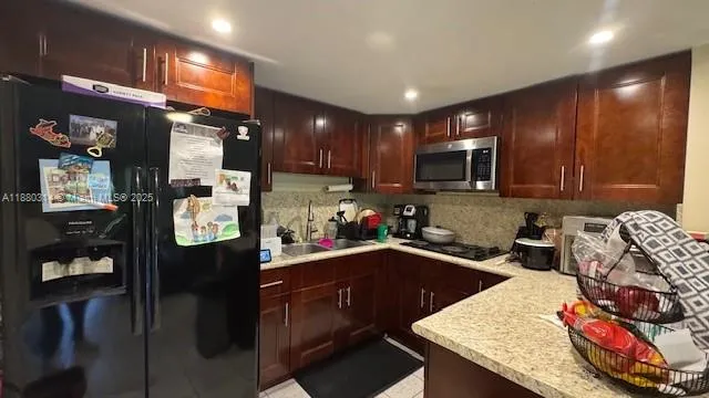 a kitchen with a sink a stove and cabinets