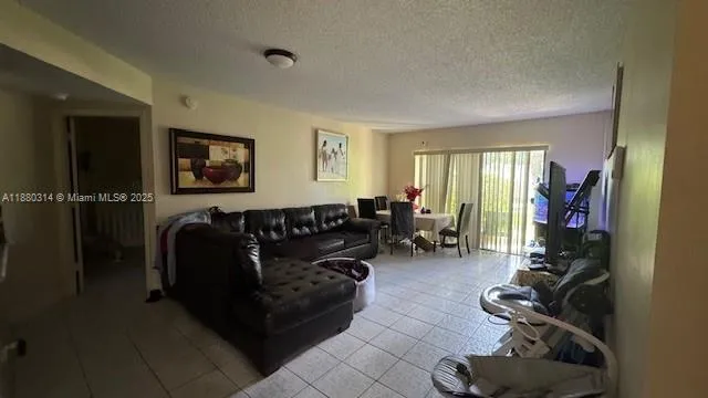 a living room with furniture a ceiling fan and a window