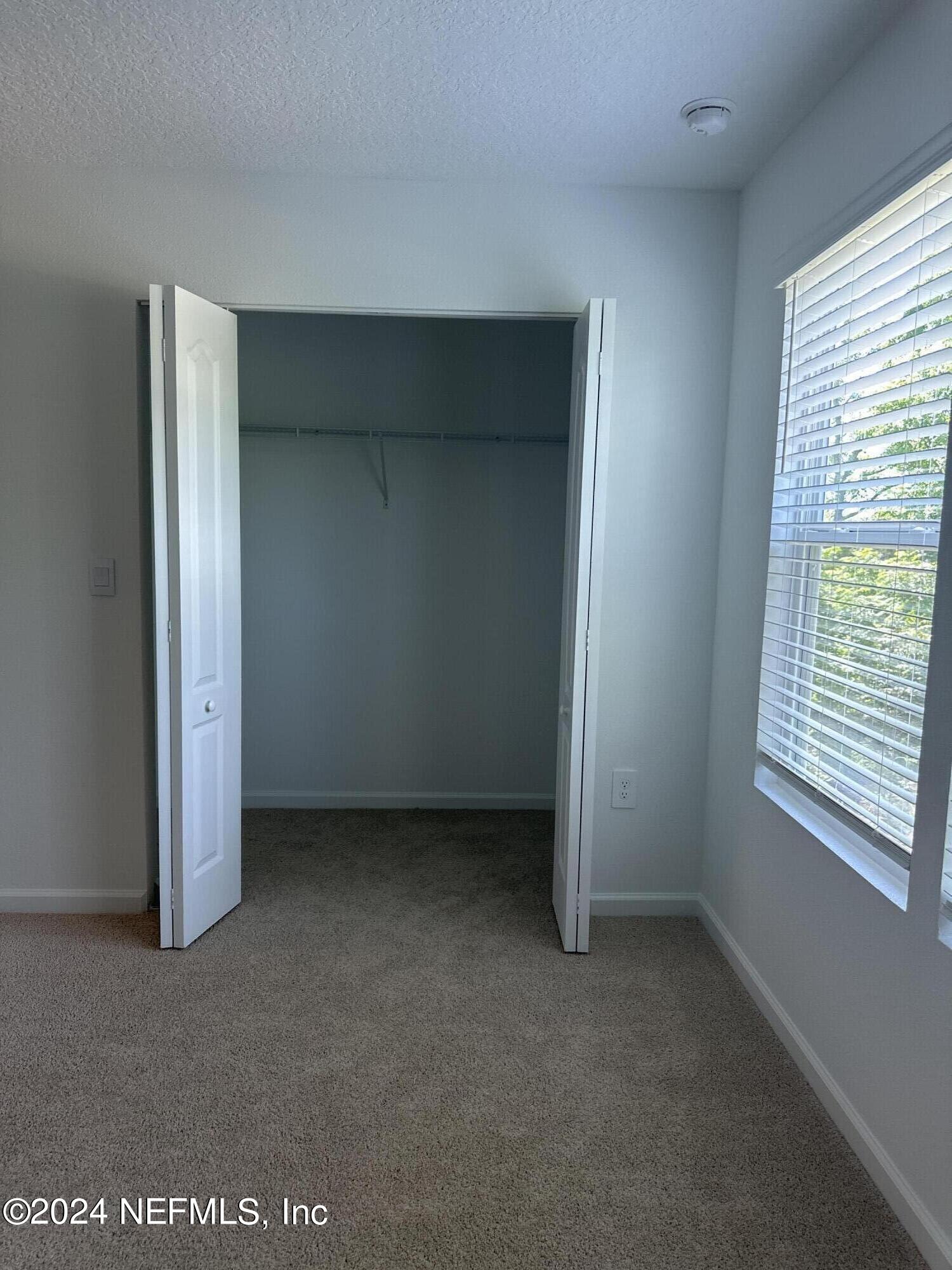 168 Tidal Bch Avenue St. Augustine, FL 32095 - Photo 13 of 36 a view of an empty room with a window