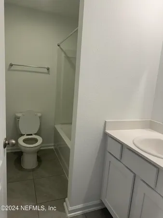 a white toilet sitting next to a white sink