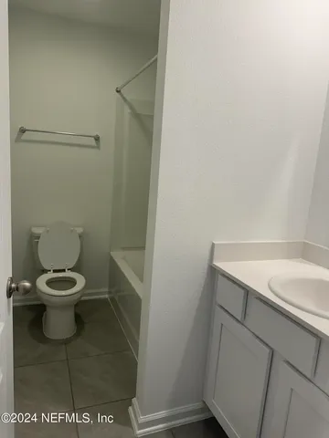 a white toilet sitting next to a white sink