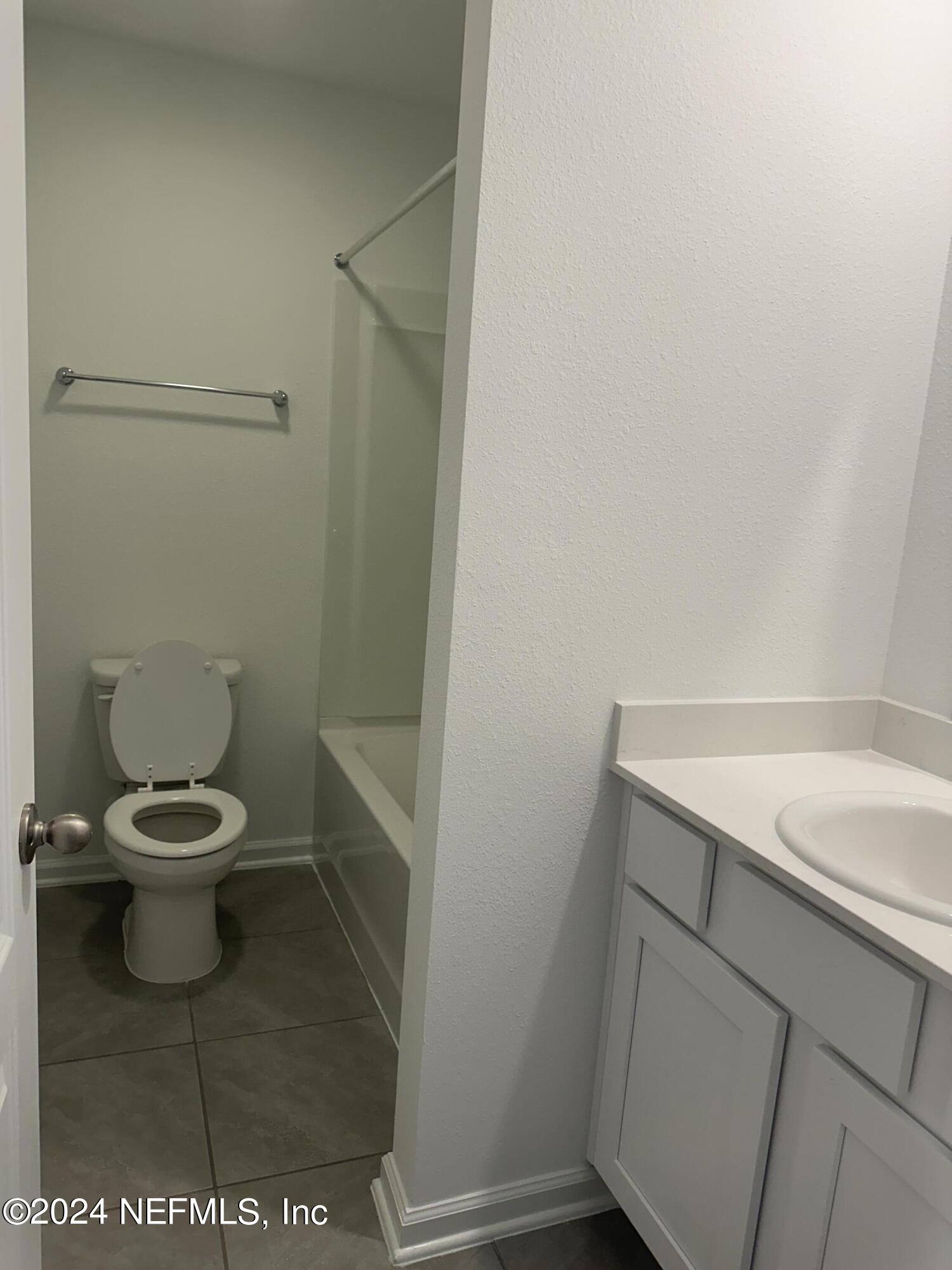 168 Tidal Bch Avenue St. Augustine, FL 32095 - Photo 18 of 36 a white toilet sitting next to a white sink