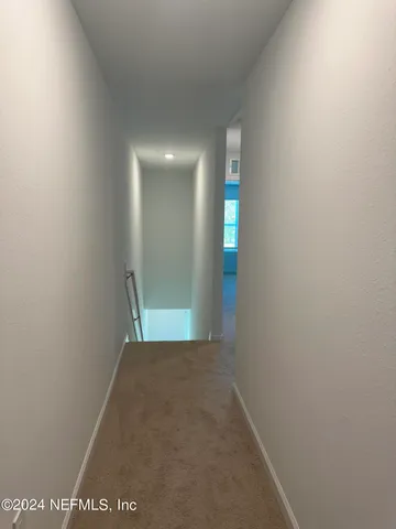 a view of a big room with an entryway