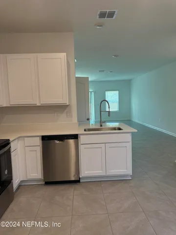 a kitchen with granite countertop a sink and a stove