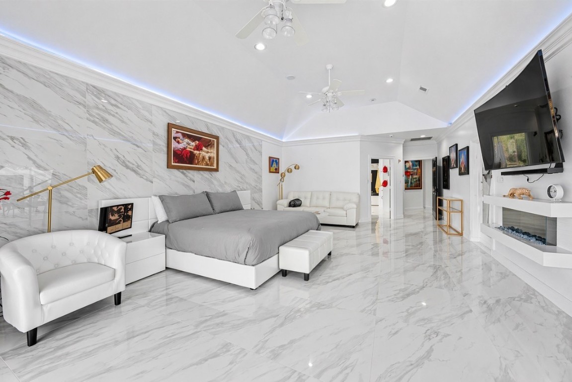 2500 Sand Shore Drive Conroe, TX 77304 - Photo 33 of 50 a spacious bedroom with a bed and a flat screen tv